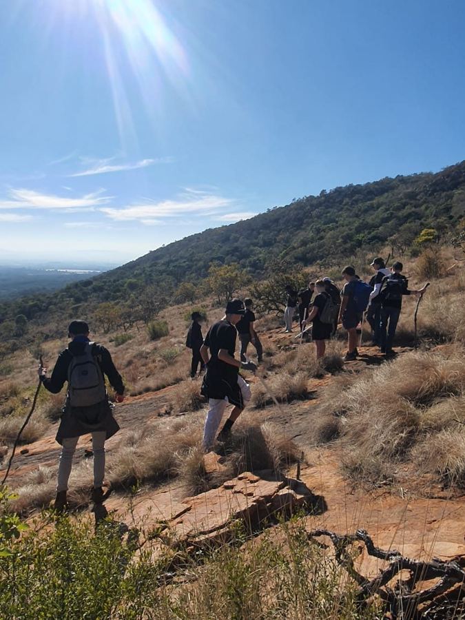Boys hiking up a mountain trail