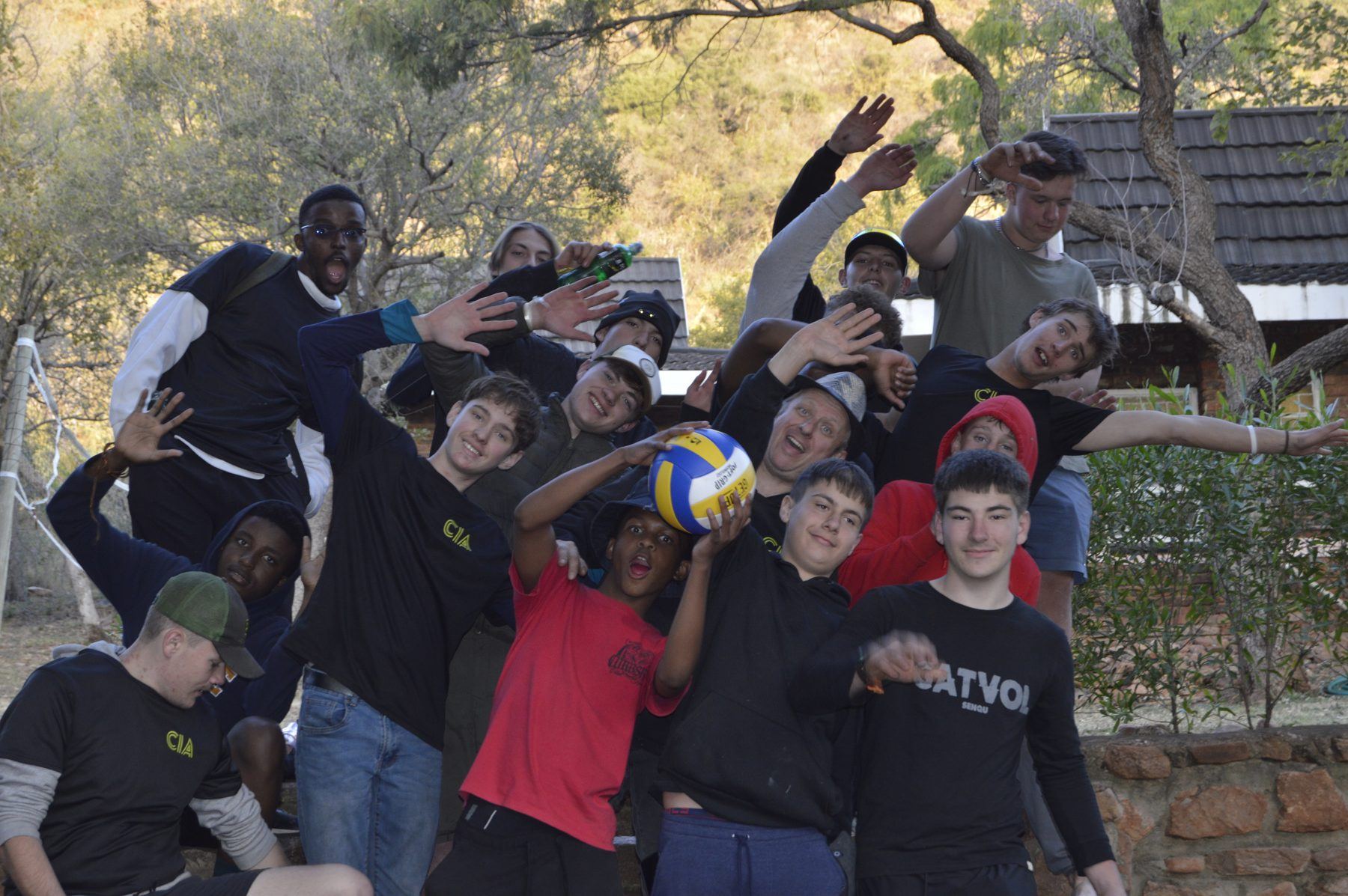 A big group of teenage boys cheering together at the CIA boys camp, July 2026